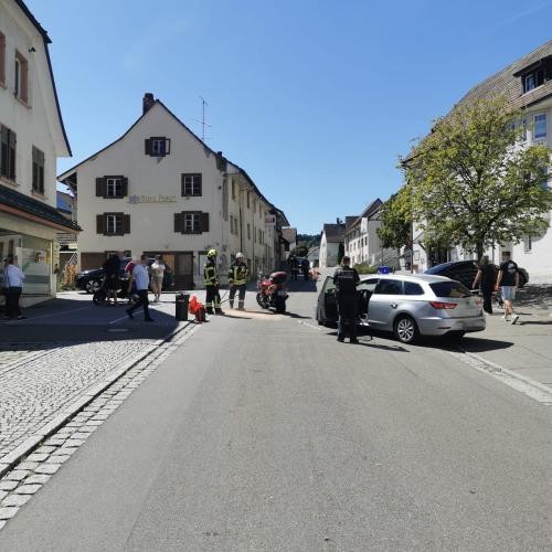 Feuerwehr und Polizei stehen vor einem verunfalltem Pkw